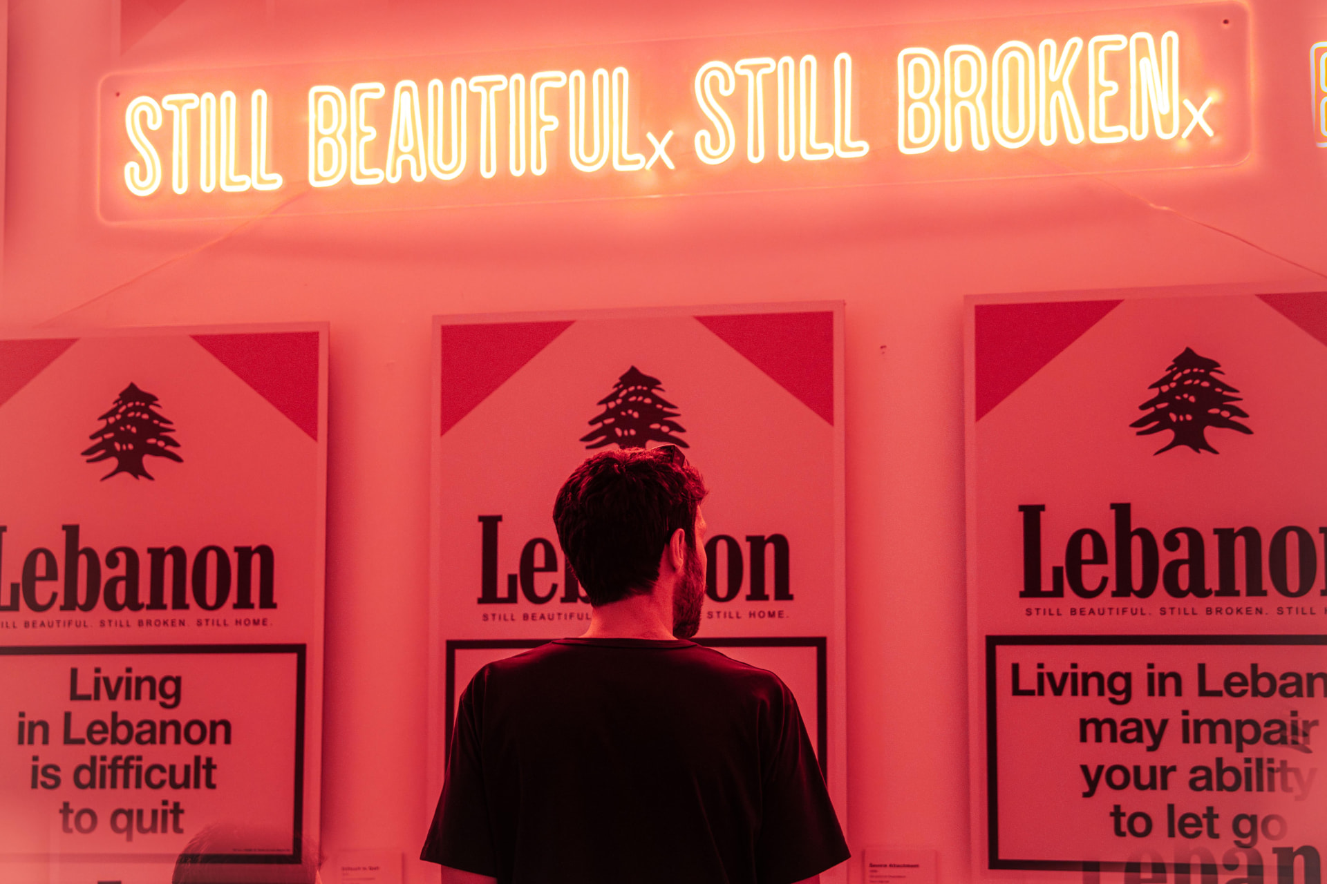 Still Beautiful. Still Broken. neon above the prints